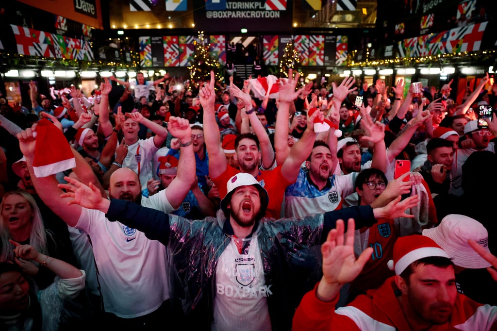 Fans gather in Croydon, London to watch England v Senegal on Sunday. Photo: Reuters Fans gather in Croydon, London to watch England v Senegal on Sunday. Photo: Reuters