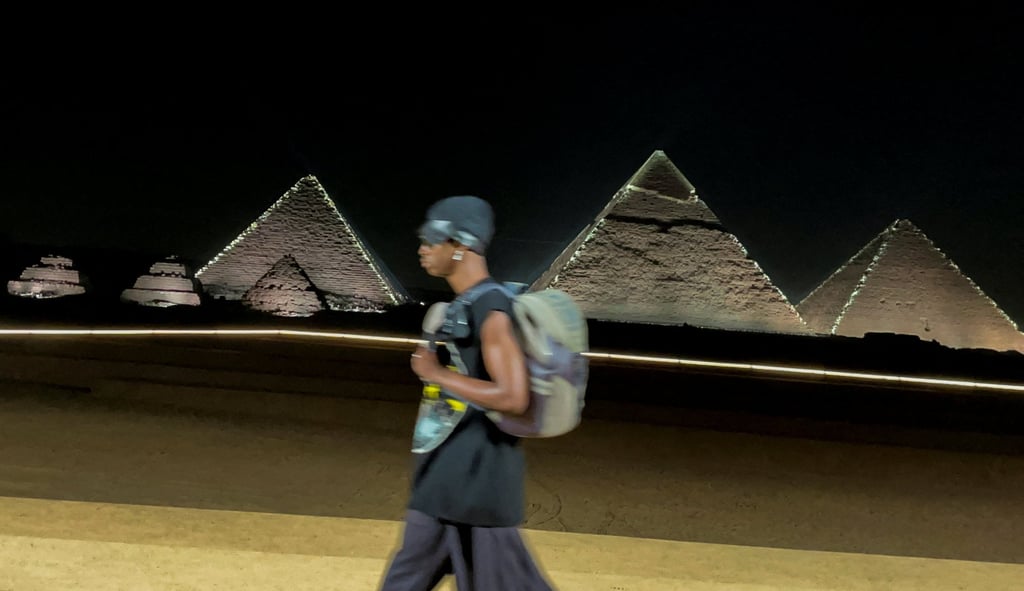 A model presents a creation by French fashion house Dior during the presentation of its men’s pre-autumn 2023 collection in front of the pyramids in Giza, on the outskirts of Cairo, Egypt, on December 3. Photo: Reuters