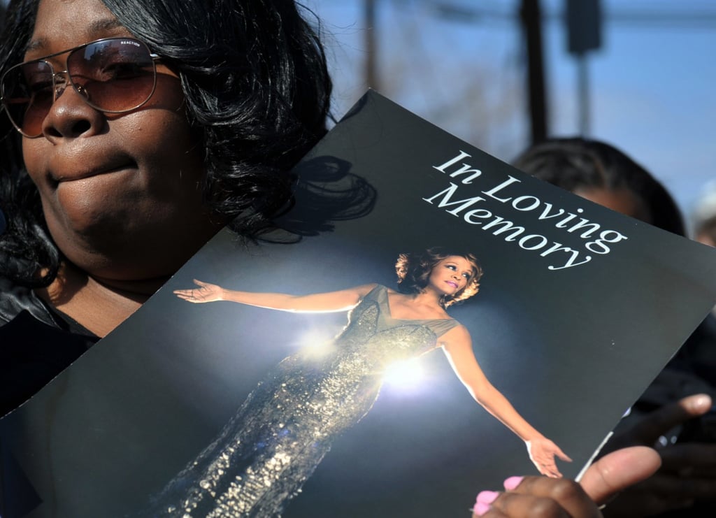 A fan holds a picture of Whitney Houston near her funeral at New Hope Baptist Church in Newark, US, in 2012. Photo: Xinhua A fan holds a picture of Whitney Houston near her funeral at New Hope Baptist Church in Newark, US, in 2012. Photo: Xinhua
