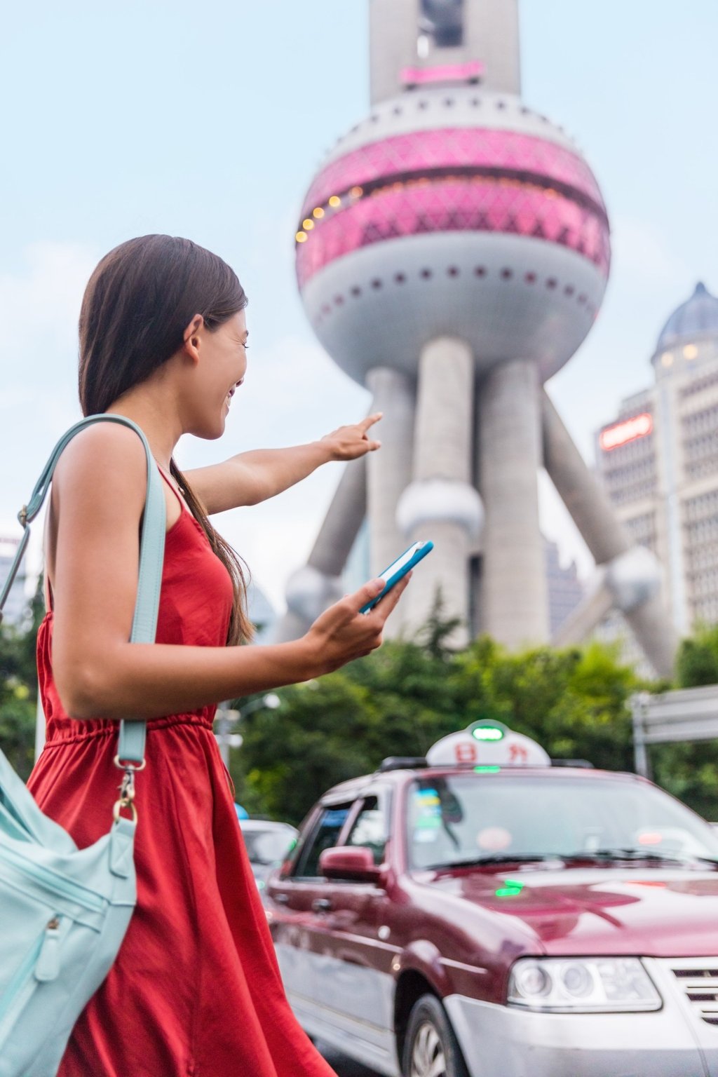 A woman hails a Shanghai taxi cab using a smartphone app. Photo: Shutterstock A woman hails a Shanghai taxi cab using a smartphone app. Photo: Shutterstock