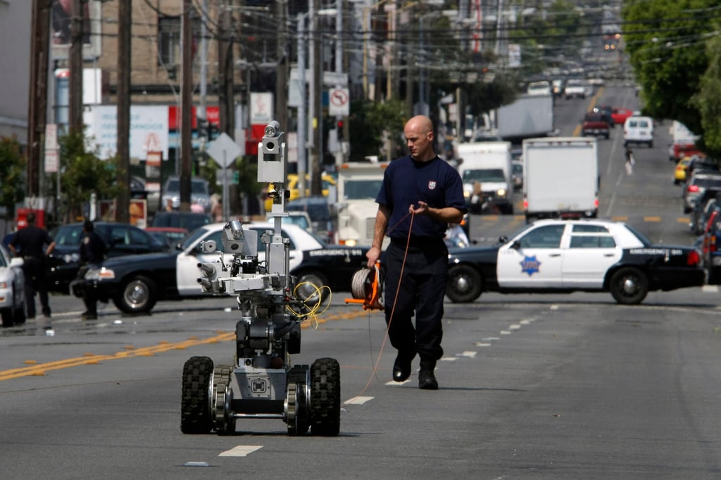 A police officer uses a robot to investigate a bomb threat in San Francisco. Robot technology for policing has become more widely available. Photo: San Francisco Chronicle via AP A police officer uses a robot to investigate a bomb threat in San Francisco. Robot technology for policing has become more widely available. Photo: San Francisco Chronicle via AP