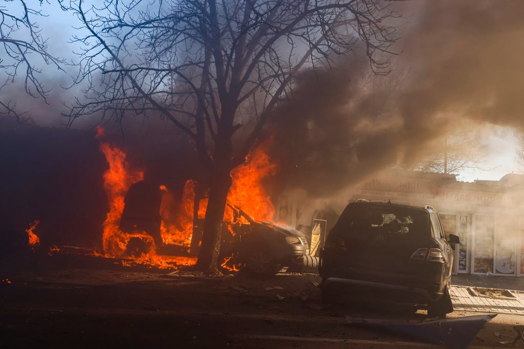 Cars burn after rockets hit residential buildings and a food market in Donetsk, Ukraine, on Tuesday. Photo: EPA-EFE