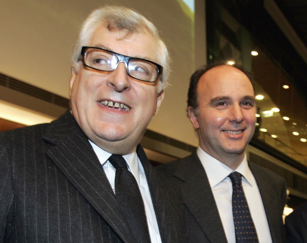 They go way back: Prada Group’s president and CEO Patrizio Bertelli and ex-Luxottica CEO Andrea Guerra smile during a meeting in Milan, in 2005. Photo: AP They go way back: Prada Group’s president and CEO Patrizio Bertelli and ex-Luxottica CEO Andrea Guerra smile during a meeting in Milan, in 2005. Photo: AP