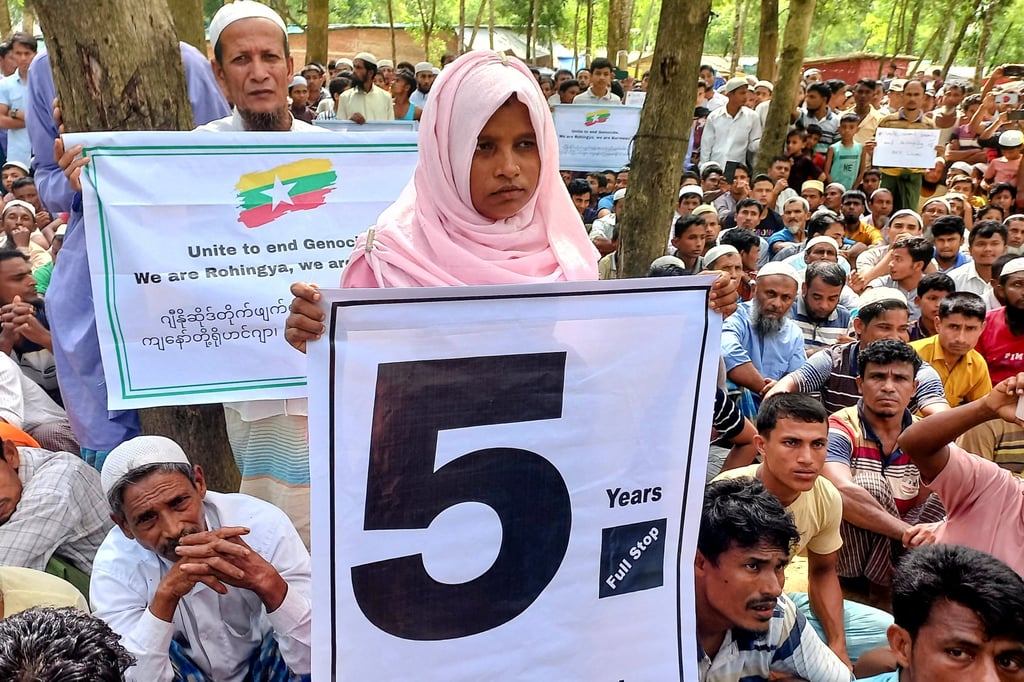 Rohingya refugees in Bangladesh hold placards as they gather at the Kutupalong Refugee Camp to mark the fifth anniversary of their fleeing from neighbouring Myanmar. Photo: Reuters Rohingya refugees in Bangladesh hold placards as they gather at the Kutupalong Refugee Camp to mark the fifth anniversary of their fleeing from neighbouring Myanmar. Photo: Reuters