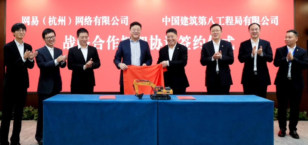 NetEase founder and chief executive William Ding Lei, fourth from left, poses with executives from Fuxi Lab and China Construction Eighth Engineering Division during the signing ceremony for their deal to jointly develop smart robots for the construction industry. Photo: Weibo