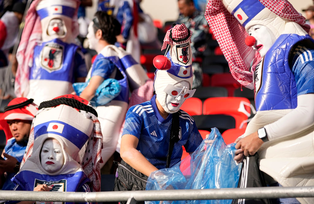 Japanese fans clean the stand of rubbish at the Ahmad Bin Ali Stadium in Al Rayyan, Qatar, after their team’s defeat to Costa Rica in the 2022 Fifa World Cup. Photo: AP