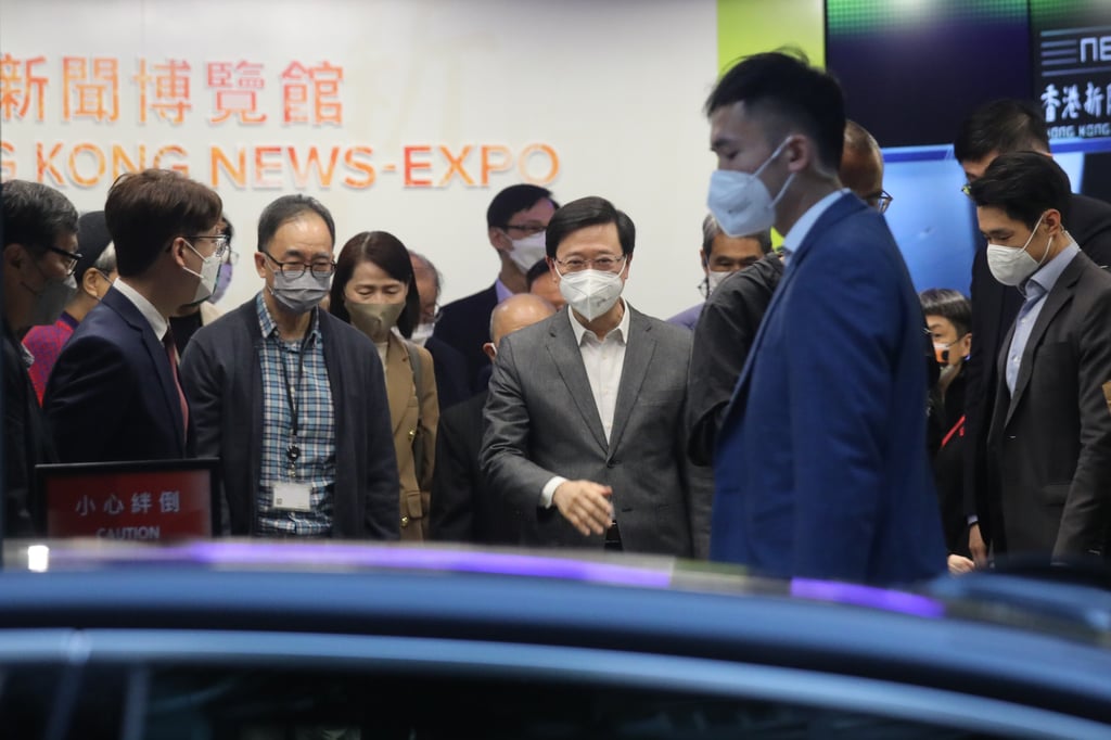 Chief Executive John Lee (centre) leaves the Hong Kong News-Expo after a closed doors briefing session. Photo: Xiaomei Chen