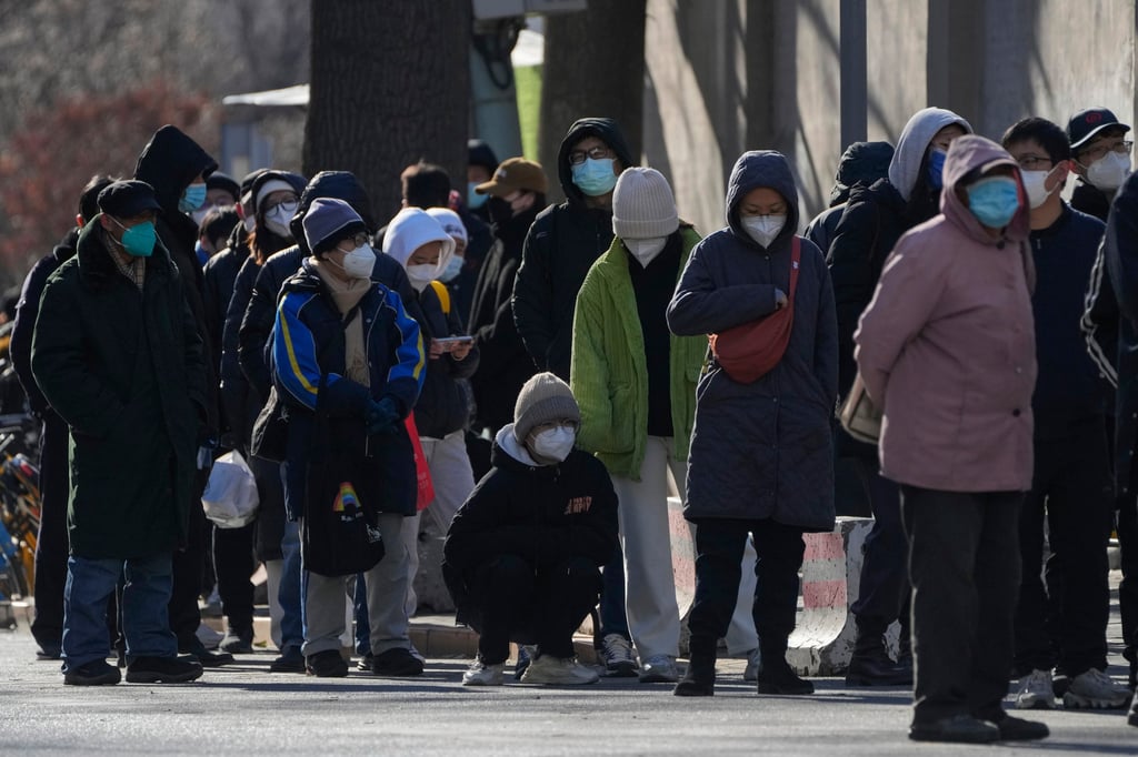 Residents line up to enter the fever clinic of a hospital in Beijing on Sunday, as the city faces a surge in Covid-19 cases amid a roll-back of anti-virus controls. Photo: AP Photo