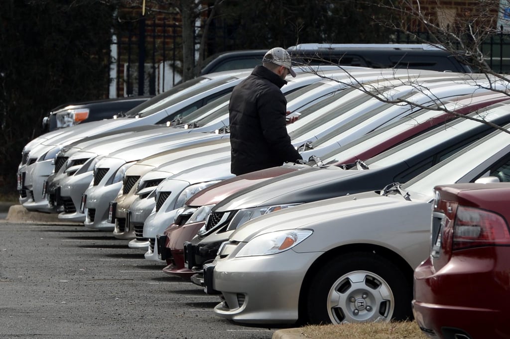 A man walks beside vehicles on the lot of a Toyota showroom in the US. Photo: EPA/File A man walks beside vehicles on the lot of a Toyota showroom in the US. Photo: EPA/File
