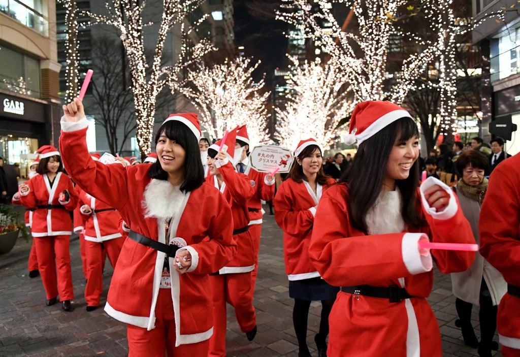 Shop workers dressed in Santa Claus costumes join a Christmas parade in the streets of Tokyo. Photo: AFP Shop workers dressed in Santa Claus costumes join a Christmas parade in the streets of Tokyo. Photo: AFP