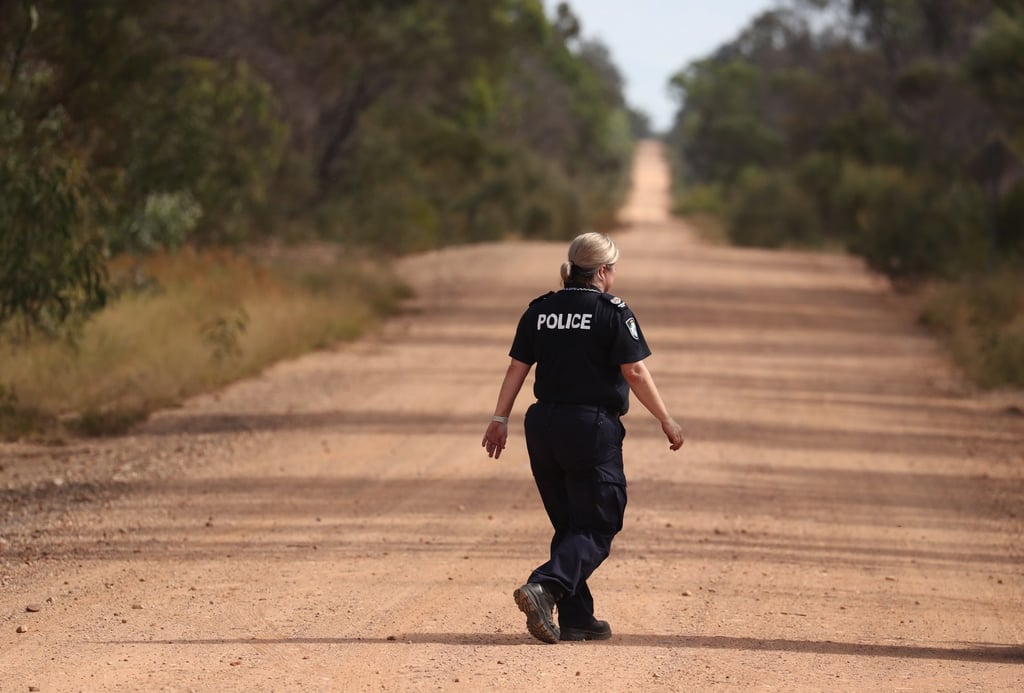 An Australian policewoman patrols near the scene of the fatal shooting in Wieambilla, Queensland, on Tuesday. Photo: EPA-EFE