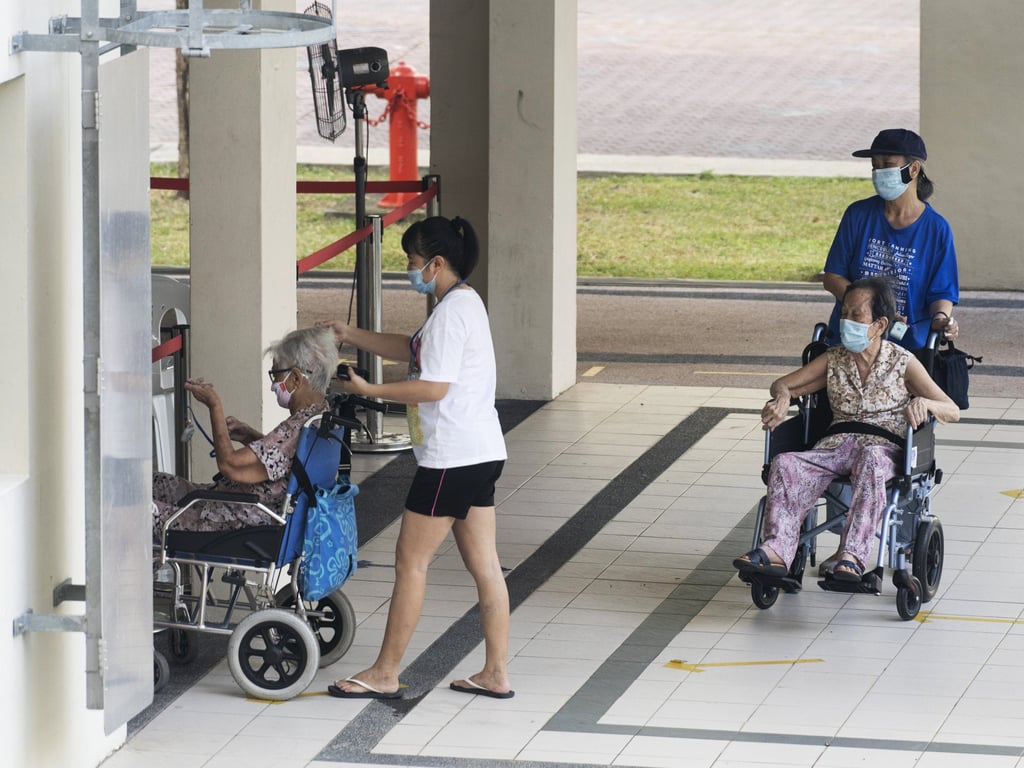 Elderly residents wait to receive a dose of Covid-19 vaccine in Singapore last year. Photo: Bloomberg