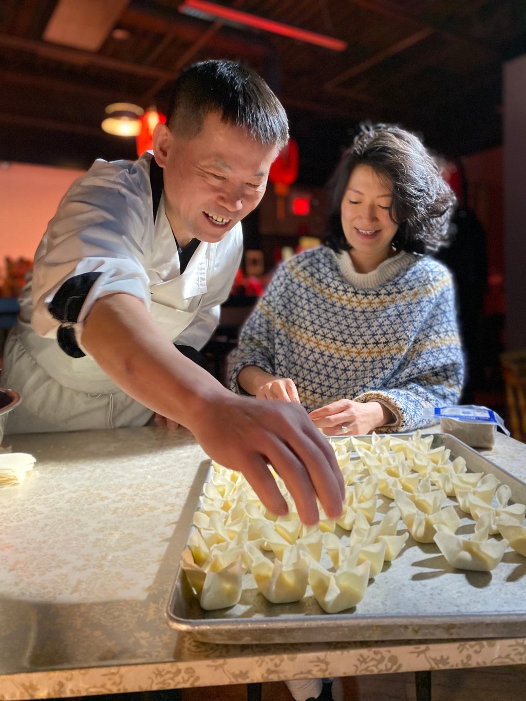 Jackie Kai Ellis making cream cheese wontons with a chef in an episode of House Special. Photo: Telus originals Jackie Kai Ellis making cream cheese wontons with a chef in an episode of House Special. Photo: Telus originals
