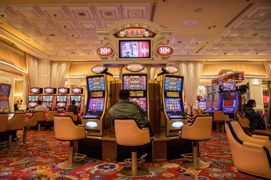 Visitors try their luck on slot machines at a casino in Macau. Photo: AFP
