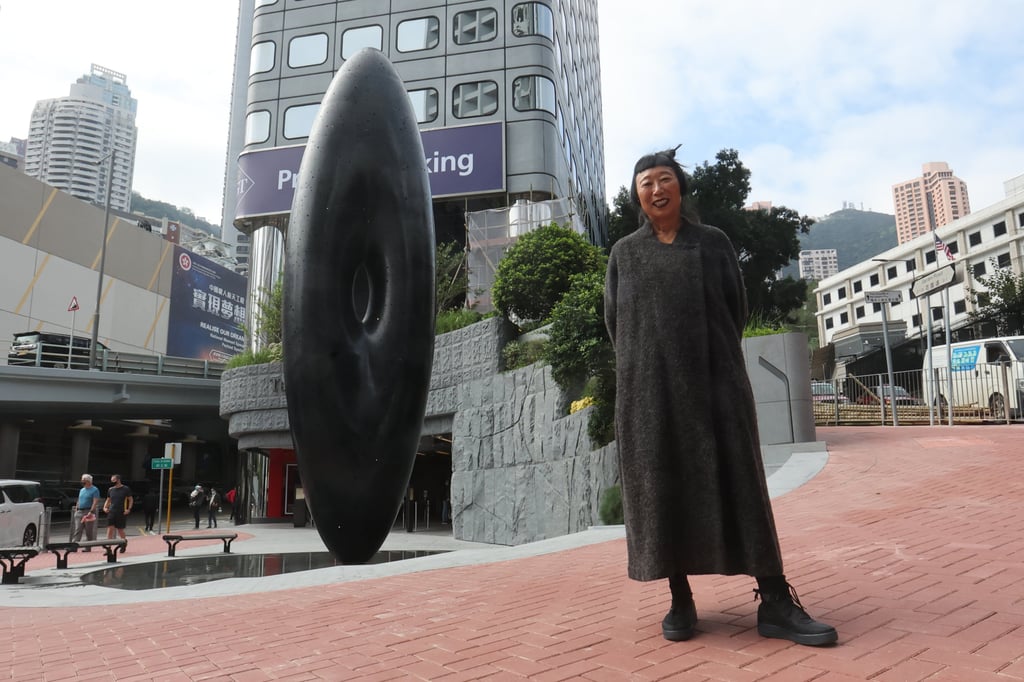 Artist Lindy Lee and her artwork “Eye of Infinity” at Hong Kong’s Peak Tram terminus in Central. “I’m not particularly interested in art that hits you over the head with its concept,” she says. Photo: Edmond So