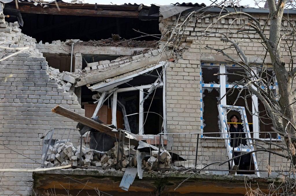 A woman measures size of a broken hospital window following recent shelling in Donetsk, Russian-controlled Ukraine on Thursday. Photo: Reuters A woman measures size of a broken hospital window following recent shelling in Donetsk, Russian-controlled Ukraine on Thursday. Photo: Reuters