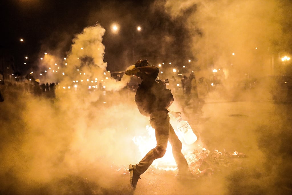 Protesters clash with police outside the Palace of Justice in Lima, Peru on Thursday. Photo: EPA-EFE