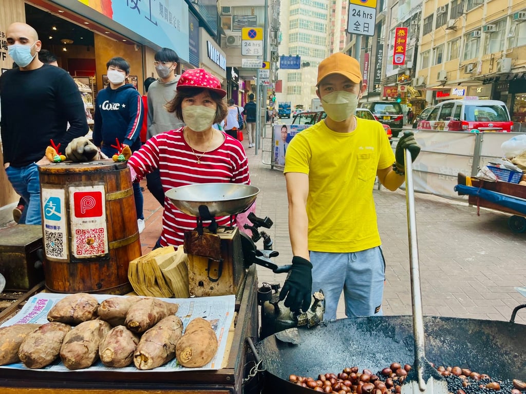 Kobus Tsang and his mother, Tsang Chi-lee Tsang, with their hawker cart in Hong Kong’s Causeway Bay district. Photo: Kylie Knott Kobus Tsang and his mother, Tsang Chi-lee Tsang, with their hawker cart in Hong Kong’s Causeway Bay district. Photo: Kylie Knott