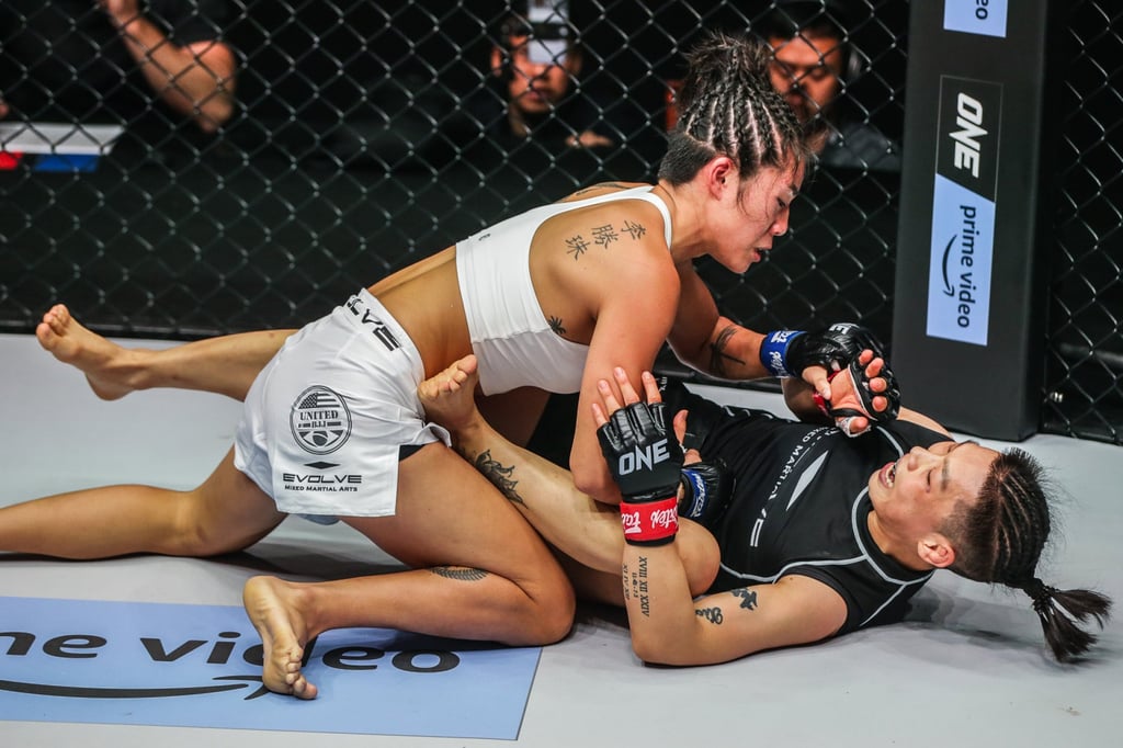 Angela Lee attacks Xiong Jingnan from top position at ONE on Prime Video 2 in Singapore. Angela Lee attacks Xiong Jingnan from top position at ONE on Prime Video 2 in Singapore.