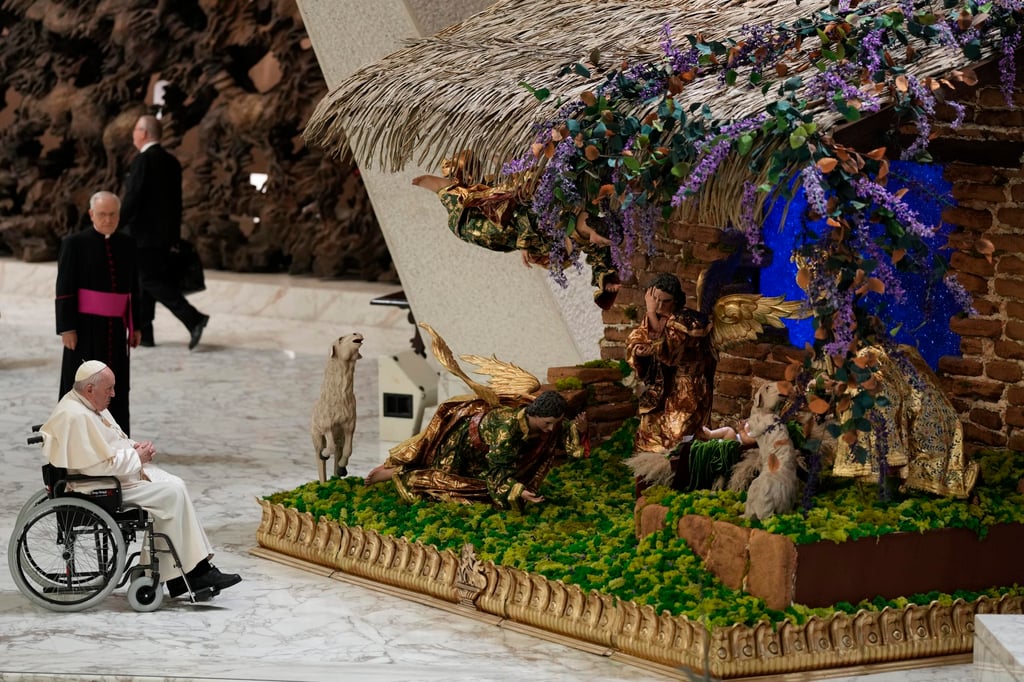 Pope Francis looks at a nativity scene at the Vatican. Photo: AP Pope Francis looks at a nativity scene at the Vatican. Photo: AP