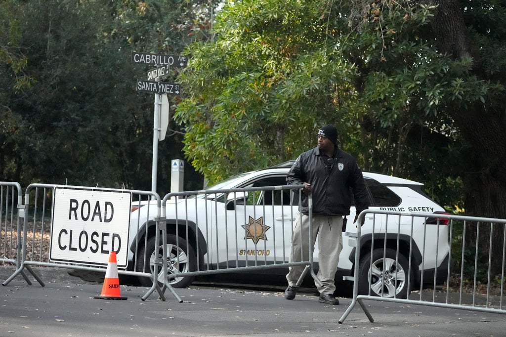 A guard closes barricades to a street near the family home of FTX founder Sam Bankman-Fried in Palo Alto, California, on Friday. Photo: AP A guard closes barricades to a street near the family home of FTX founder Sam Bankman-Fried in Palo Alto, California, on Friday. Photo: AP