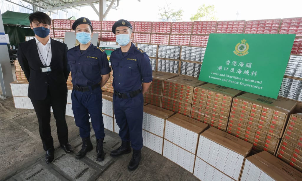 Customs officials (from left) Senior Inspector John Yip, Senior Inspector Tang Ka-chun, and Senior Inspector Choi Yin-ming with a massive haul of smuggled cigarettes intercepted by officers. Photo: Jonathan Wong Customs officials (from left) Senior Inspector John Yip, Senior Inspector Tang Ka-chun, and Senior Inspector Choi Yin-ming with a massive haul of smuggled cigarettes intercepted by officers. Photo: Jonathan Wong