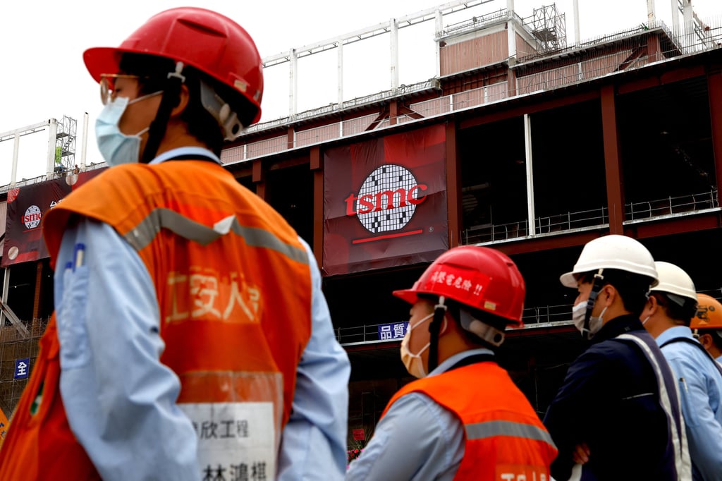 Workers attend a ceremony held by TSMC to start mass production of its most advanced 3-nanometre chips in the southern Taiwanese city of Tainan on Thursday. Photo: Reuters Workers attend a ceremony held by TSMC to start mass production of its most advanced 3-nanometre chips in the southern Taiwanese city of Tainan on Thursday. Photo: Reuters