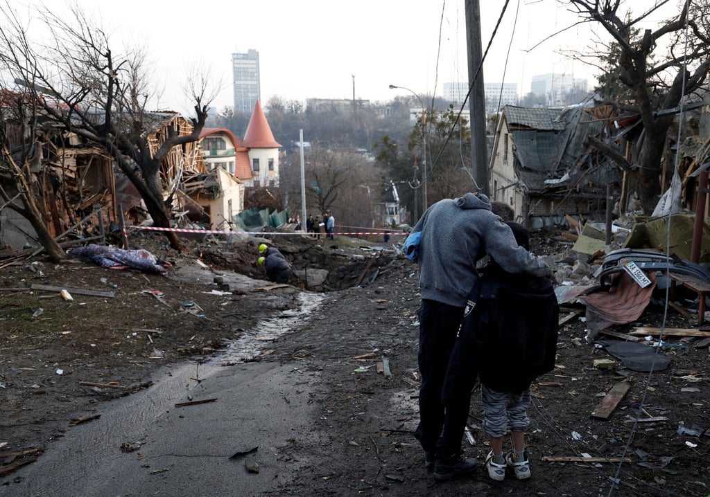 A local resident embraces his son as they stand near the site of a Russian missile strike in Kyiv, Ukraine on Saturday. Photo: Reuters A local resident embraces his son as they stand near the site of a Russian missile strike in Kyiv, Ukraine on Saturday. Photo: Reuters