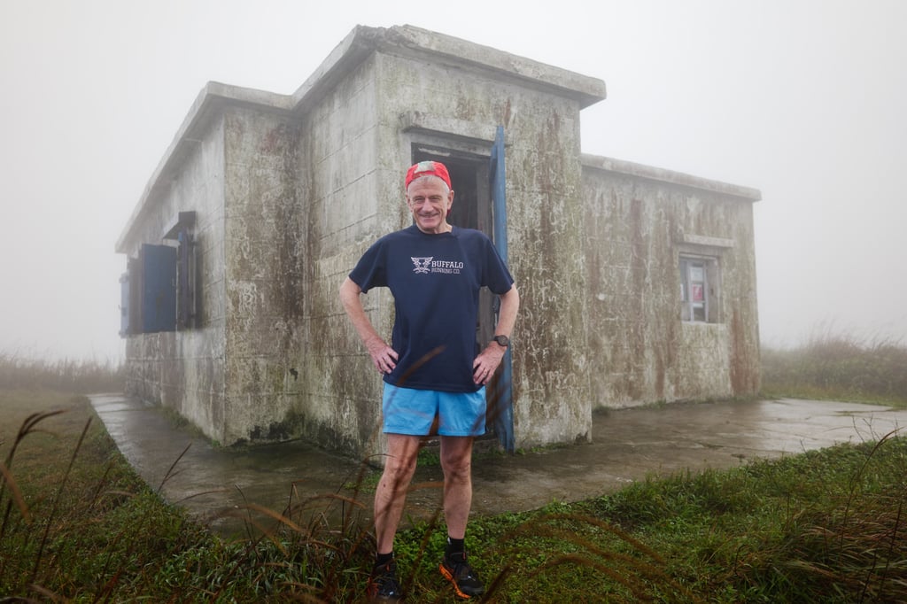 Mark Loasby outside his cabin on Sunset Peak. Photo: Daniel Suen