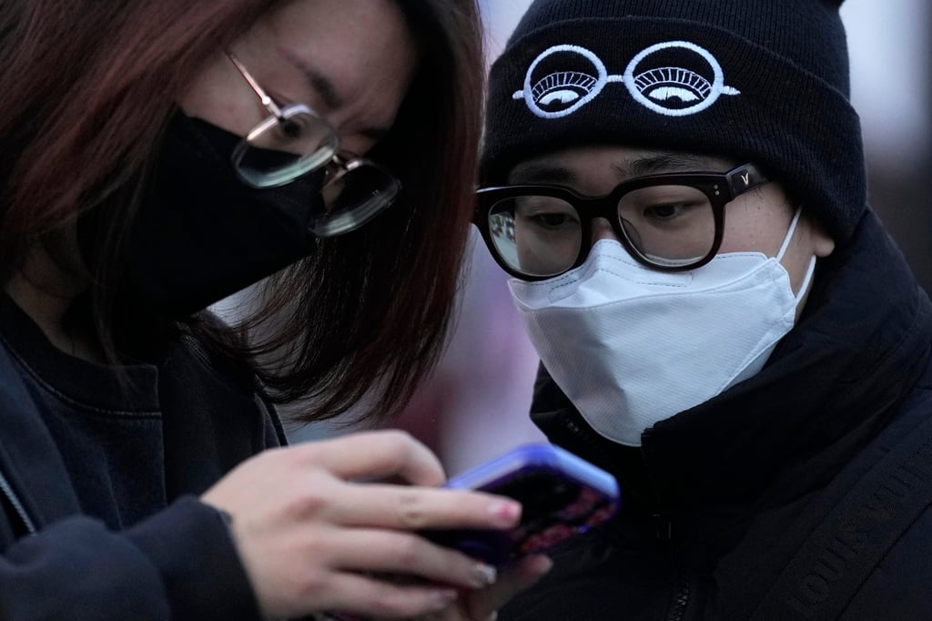 Shoppers wearing masks visit a popular mall following the easing of pandemic restrictions in Beijing. Photo: AP Shoppers wearing masks visit a popular mall following the easing of pandemic restrictions in Beijing. Photo: AP