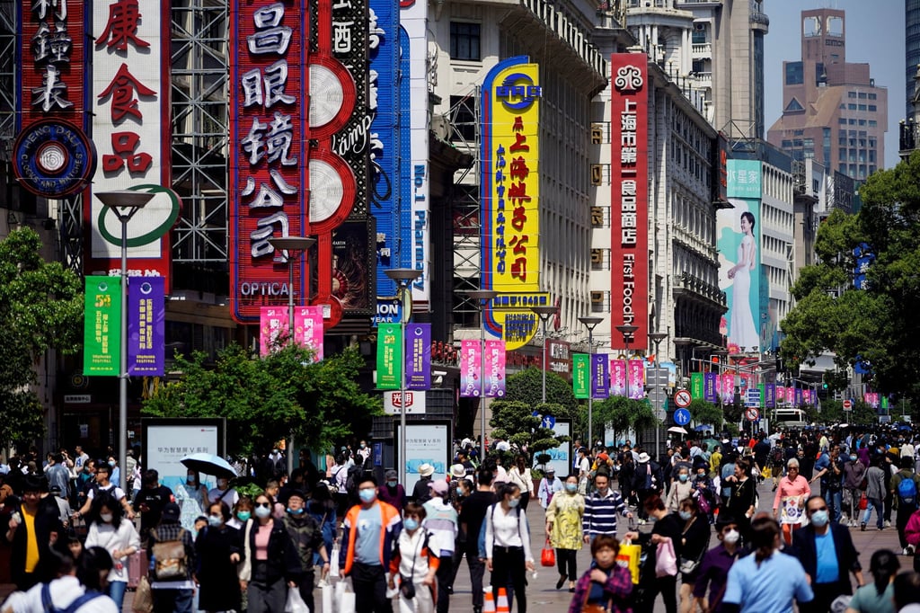 People walk along Nanjing Pedestrian Road, a main shopping area, in Shanghai. Many analysts believe that the demand for essential commodities will pick up once infections subside in China. Photo: Reuters People walk along Nanjing Pedestrian Road, a main shopping area, in Shanghai. Many analysts believe that the demand for essential commodities will pick up once infections subside in China. Photo: Reuters