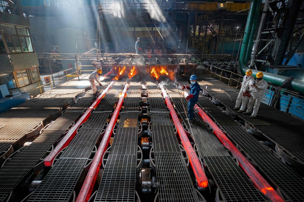 Workers make iron bars at a steel factory in eastern China. Photo: AFP