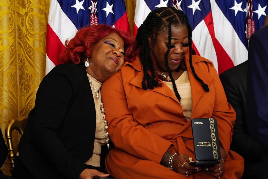 Georgia election worker Shaye Moss (right) and her mother and fellow election worker Ruby Freeman react after being awarded the Presidential Citizens Medal at the White House on Friday. Photo: EPA-EFE