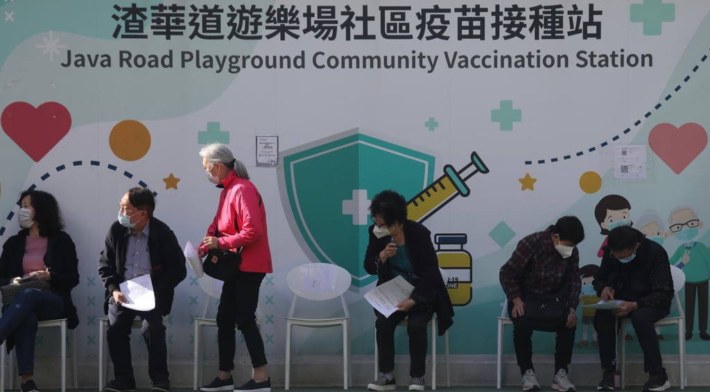 People queue up for Covid-19 jabs outside a community vaccination station in Hong Kong. Photo: Xiaomei Chen