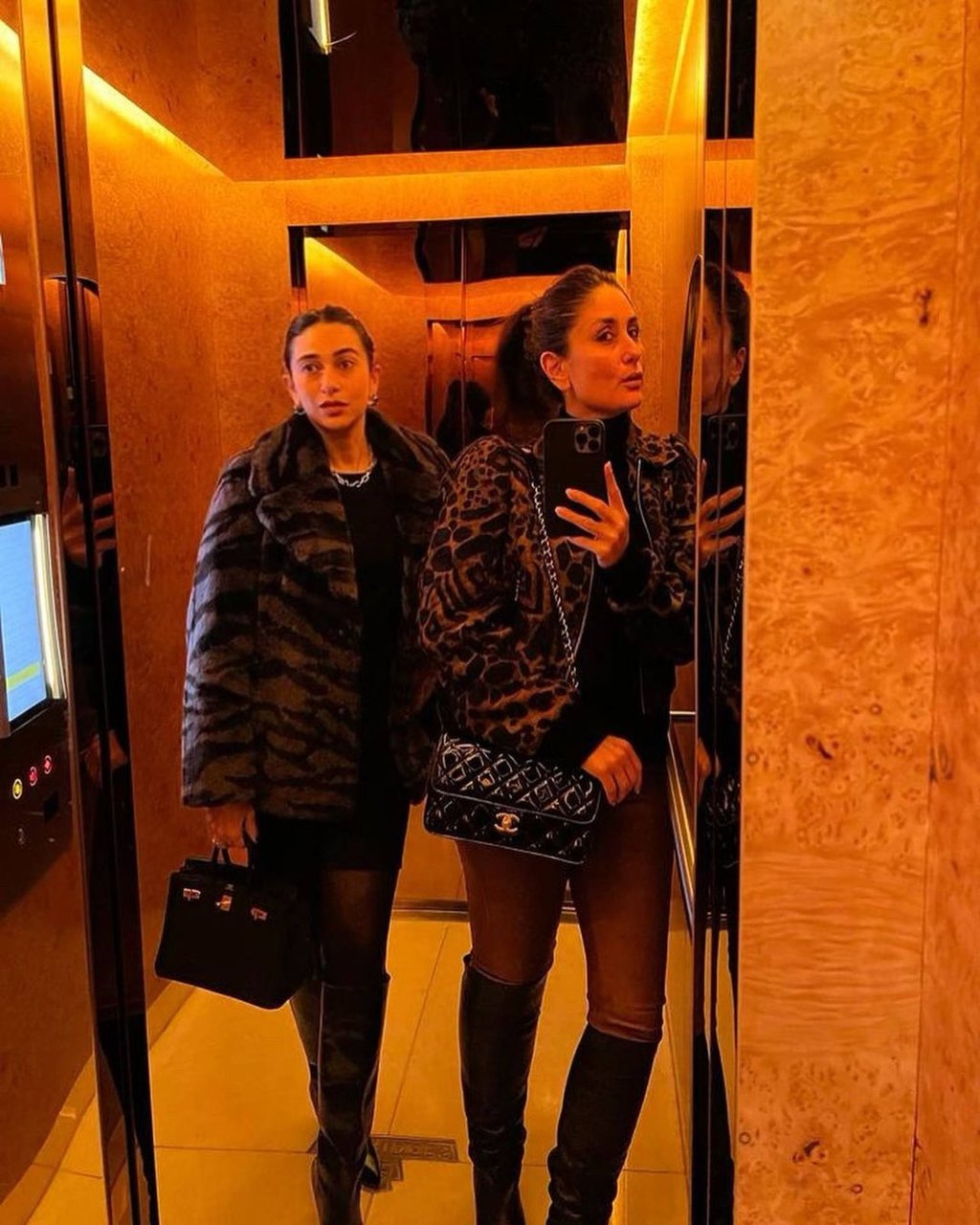 Karisma and Kareena Kapoor pose with their designer handbags and animal-print coats. Photo: @kareenakapoorkhan/Instagram