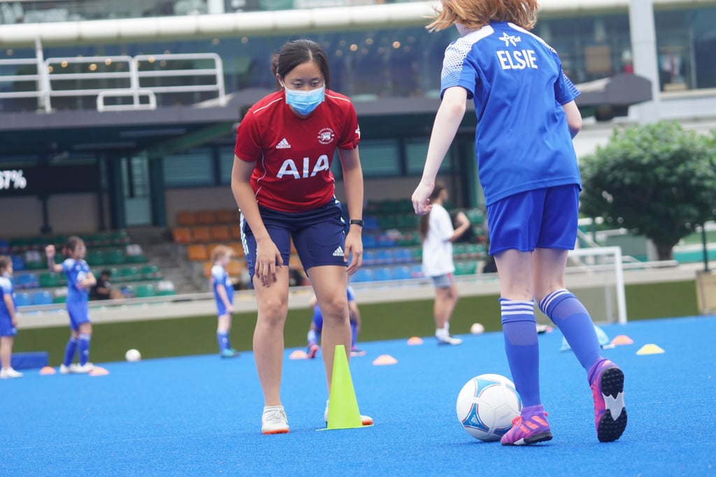 Alyson Shick, girls coach (in red woman). The Junior Soccer programme at Hong Kong Football Club in Happy Valley. Photo: Winson Wong