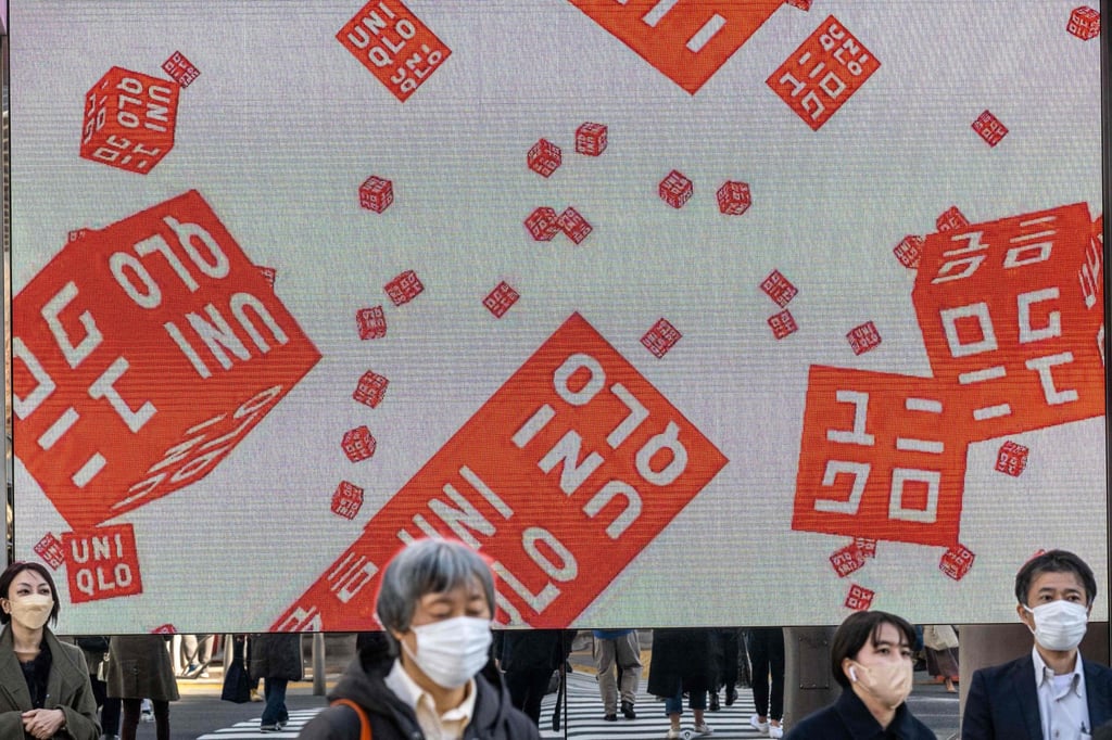 Pedestrians walk in front of a Uniqlo store operated by Japan’s Fast Retailing in Tokyo on January 11, 2023. Photo: AFP