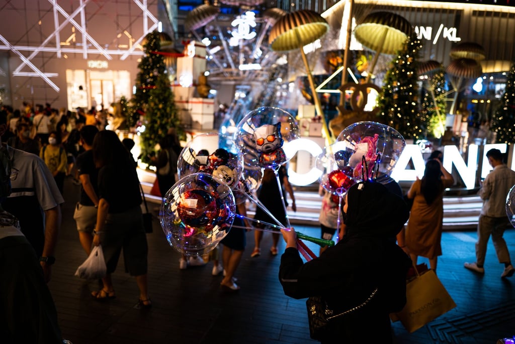 A woman sells balloons outside a shopping centre in Kuala Lumpur. Not everyone is unhappy with the tax. Some say it levels the playing field for importers. Photo: Xinhua A woman sells balloons outside a shopping centre in Kuala Lumpur. Not everyone is unhappy with the tax. Some say it levels the playing field for importers. Photo: Xinhua