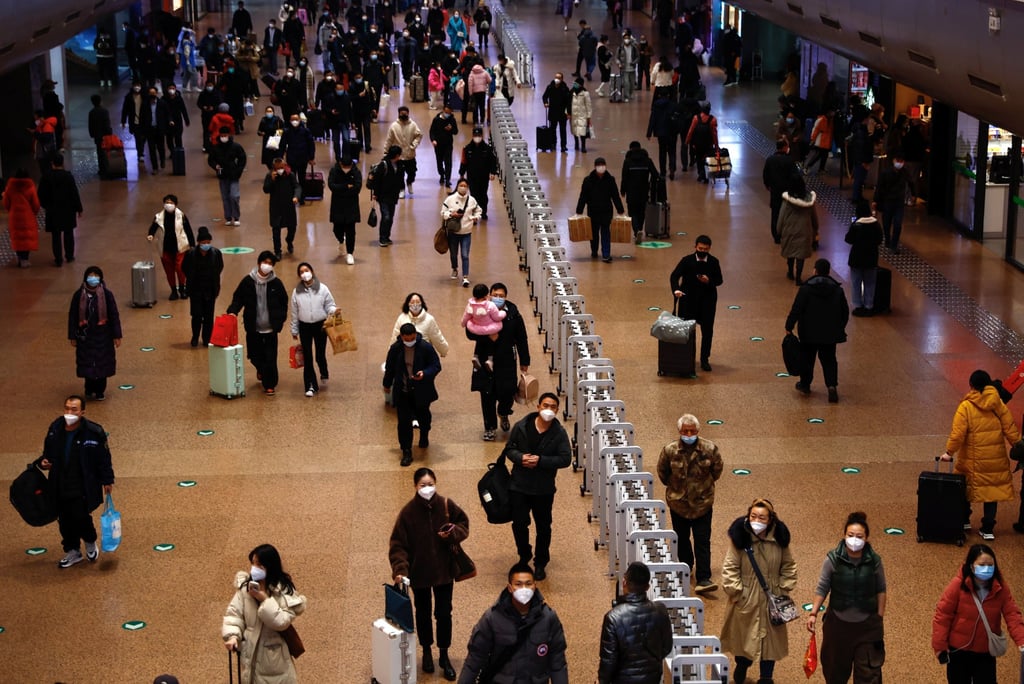 People walk with their luggage at a railway station in Beijing on January 13, 2023 during the annual travel rush ahead of the Chinese Lunar New Year. Photo: Reuters People walk with their luggage at a railway station in Beijing on January 13, 2023 during the annual travel rush ahead of the Chinese Lunar New Year. Photo: Reuters
