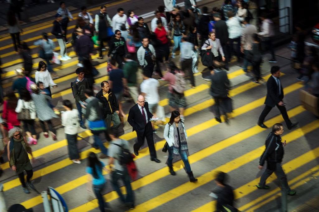 Pedestrians cross a road in the Central district of Hong Kong, in 2017. Photo: Bloomberg