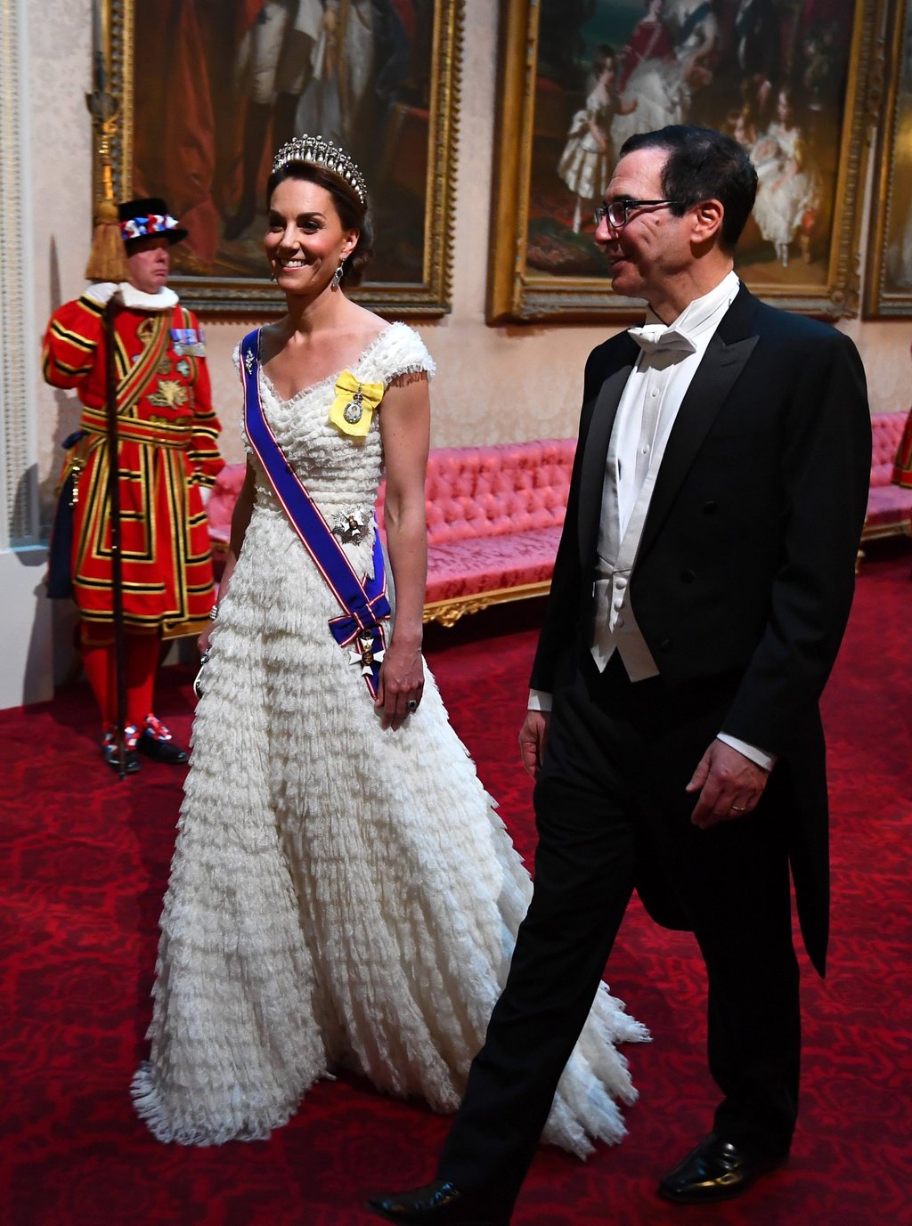 Catherine, Duchess of Cambridge and United States secretary of the treasury, Steven Mnuchin arrive through the East Gallery for a State Banquet at Buckingham Palace in June 2019, in London, England. Photo: Getty Images