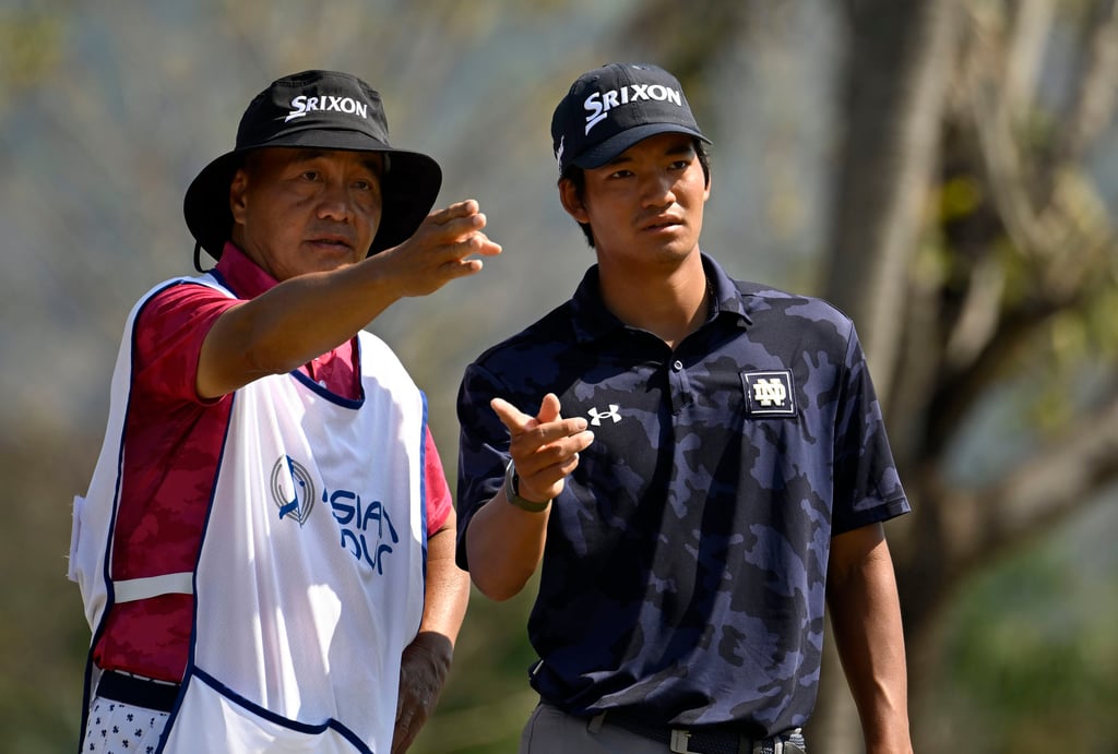 Hong Kong amateur Taichi Kho discusses a shot with dad Victor during the third round at Lake View Resort and Golf Club. Photo: Asian Tour. Hong Kong amateur Taichi Kho discusses a shot with dad Victor during the third round at Lake View Resort and Golf Club. Photo: Asian Tour.