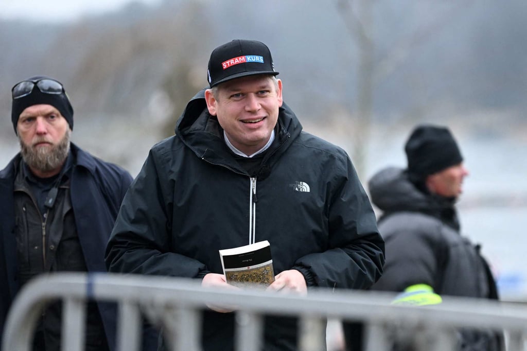 Danish anti-Islam activist Rasmus Paludan holds the Koran during a protest outside the Turkish embassy in Stockholm, Sweden, on Saturday. Photo: TT News Agency/AFP