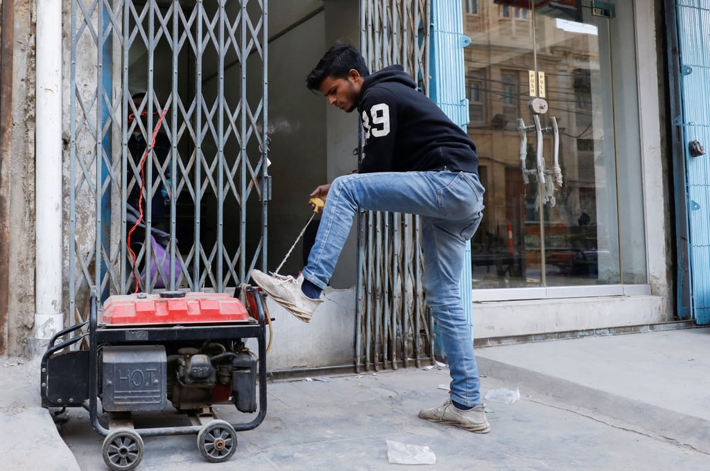 A man starts a generator outside his shop during a country-wide power breakdown in Karachi, Pakistan. Photo: Reuters A man starts a generator outside his shop during a country-wide power breakdown in Karachi, Pakistan. Photo: Reuters