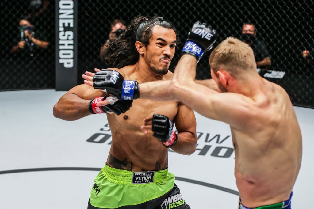 Sinsamut Klinmee throws a punch at Liam Nolan at ONE 156.