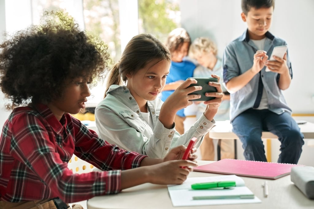 Children often use smartphones at school. But how much are they being monitored online? Photo: Shutterstock.