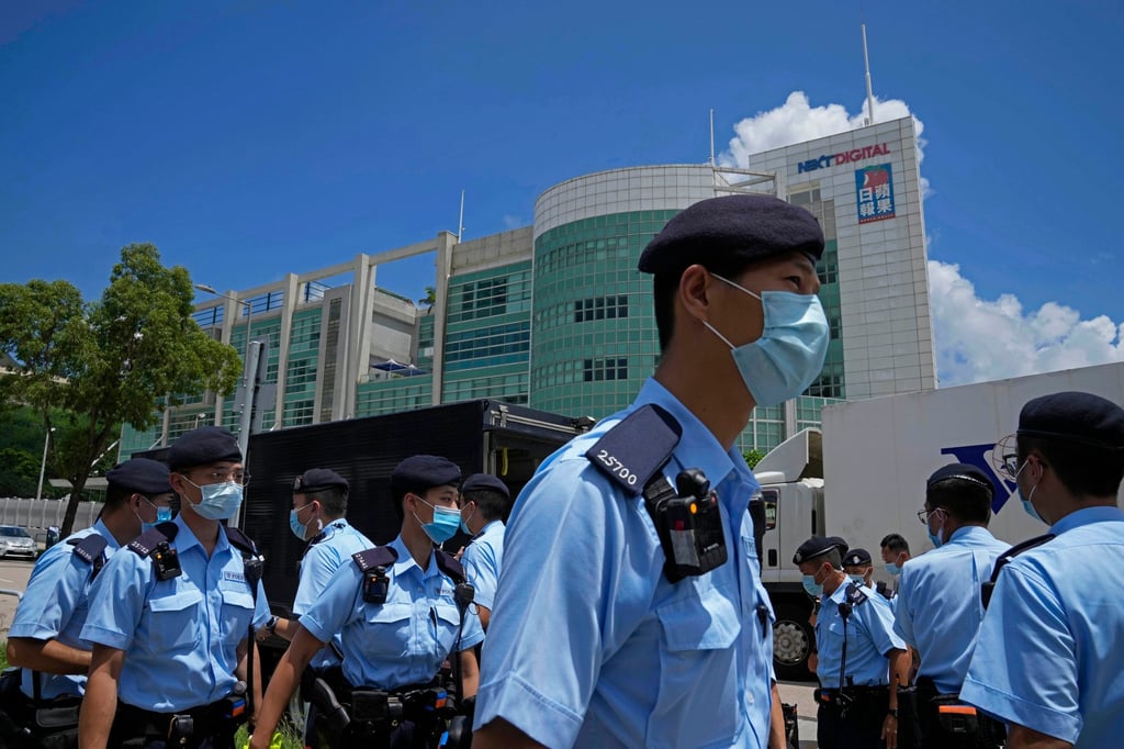 Police gathering outside the offices of the Apple Daily newspaper on June 17, 2021, after arresting the paper’s chief editor and four other senior executives under the national security law. Photo: AP