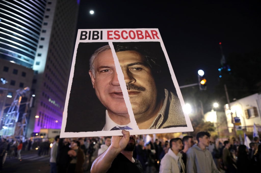 A protester holds a placard against Israeli Prime Minister Benjamin Netanyahu during a protest in Tel Aviv, Israel on Saturday. Photo: EPA-EFE