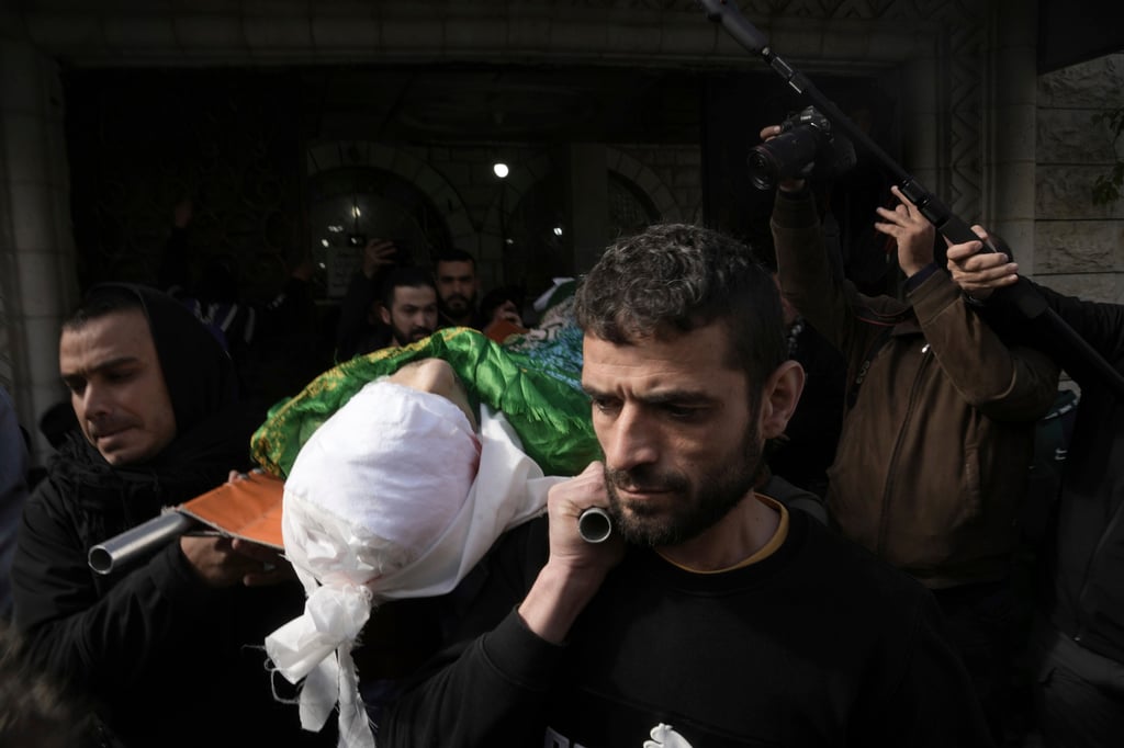 Mourners carry the body of Nassim Abu Fouda, 26, during his funeral in the West Bank on Monday. Israeli forces shot and killed the Palestinian man in Hebron, the Palestinian Health Ministry said. Photo: AP