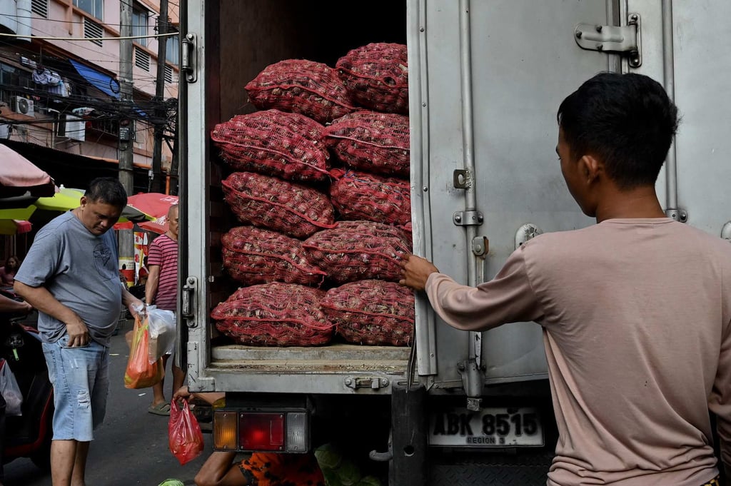 A man opens a truck with onions at a market in Manila earlier this month. Prices are soaring despite the Philippines reporting a bumper onion crop last year. Photo: AFP A man opens a truck with onions at a market in Manila earlier this month. Prices are soaring despite the Philippines reporting a bumper onion crop last year. Photo: AFP